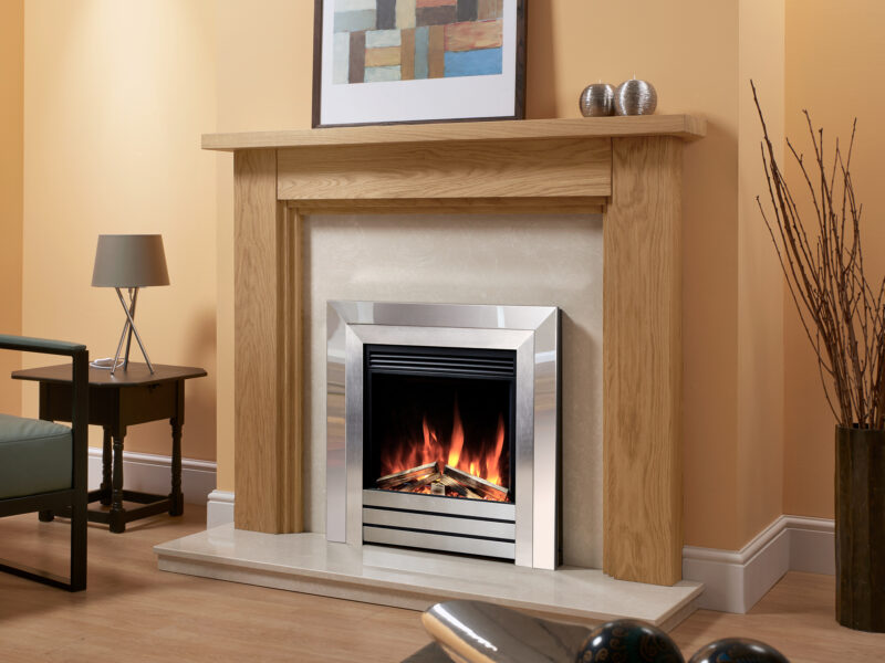 double stepped oak fireplace surround in light oiled oak against an orange chimney, fitted with a chrome electric fire.