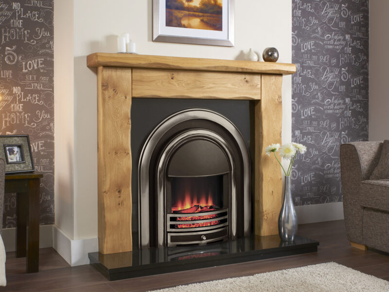 rustic oak fireplace on chimney breast with electric cast iron insert.