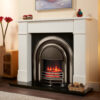 Classic marble fireplace shown in white marble with a black hearth, an electric cast iron fitted on a dark oak flooring.