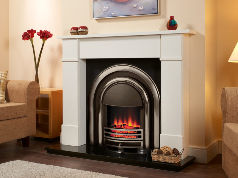 Classic marble fireplace shown in white marble with a black hearth, an electric cast iron fitted on a dark oak flooring.